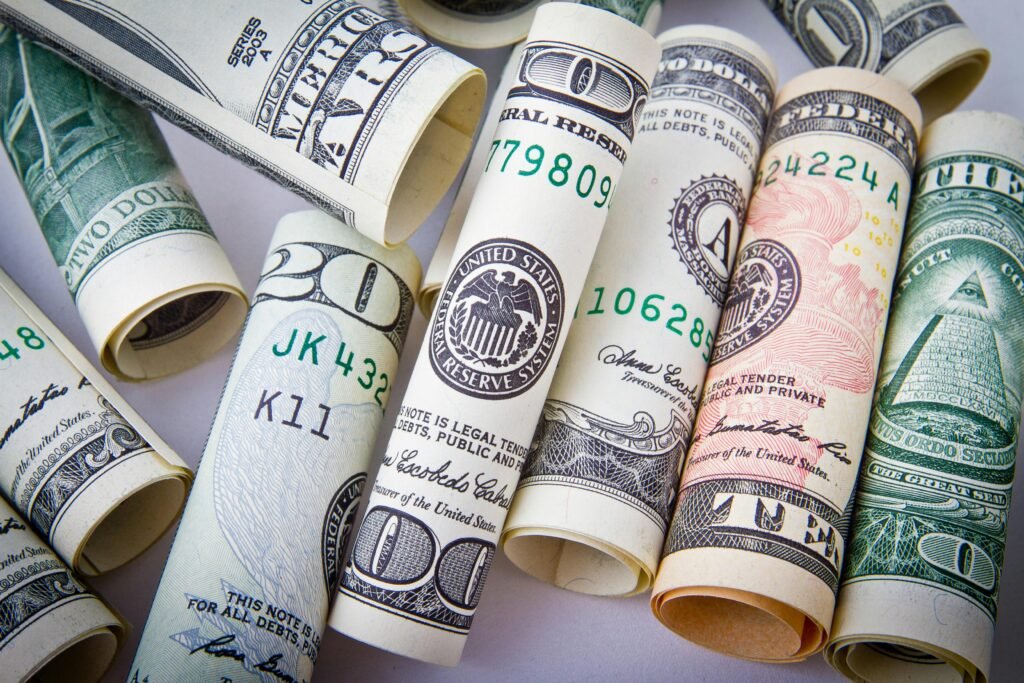 Close-up of rolled US dollar bills symbolizing wealth, financial success, and currency.